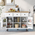 White kitchen island with open doors displaying various items in a modern kitchen.