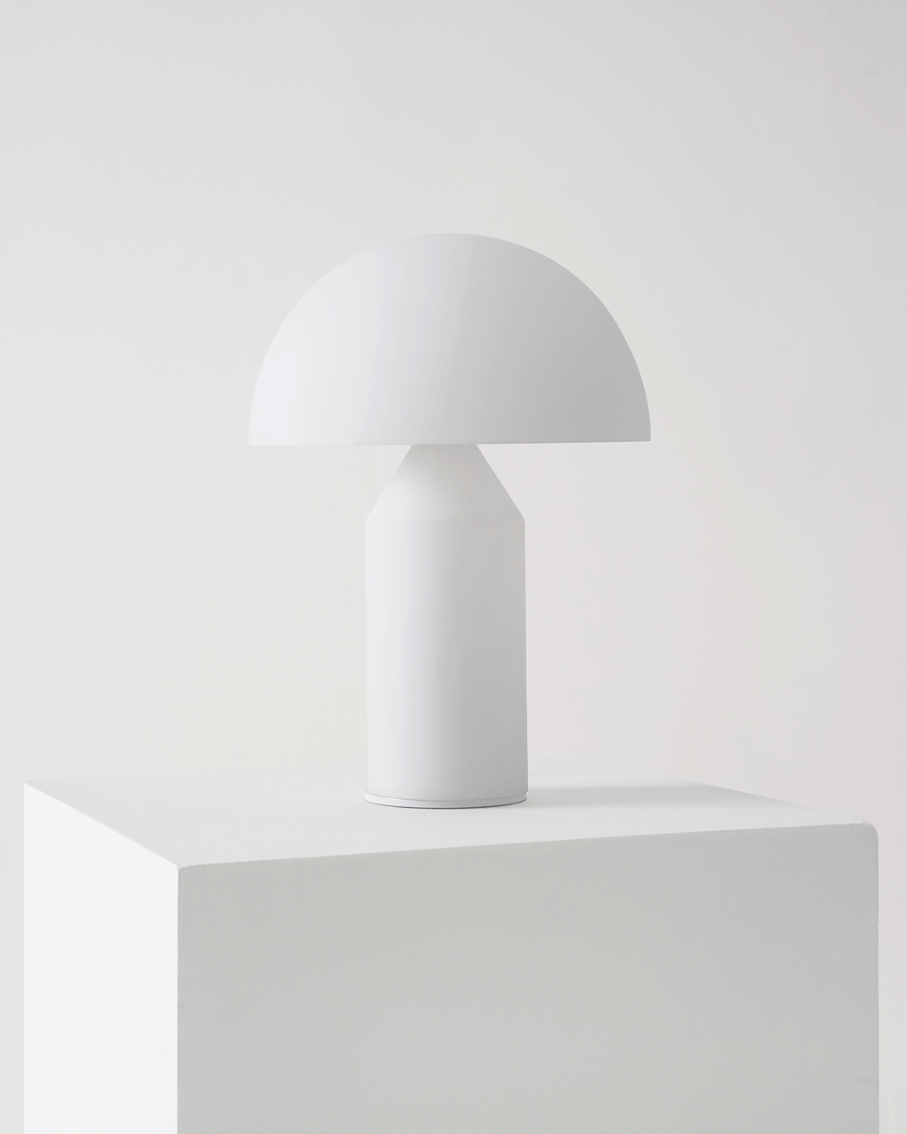 White table lamp on a white surface with a white background