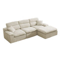 An L-shaped sectional sofa upholstered in textured cream fabric, featuring a chaise lounge on the right side and two matching throw pillows, shown on a plain white background.
